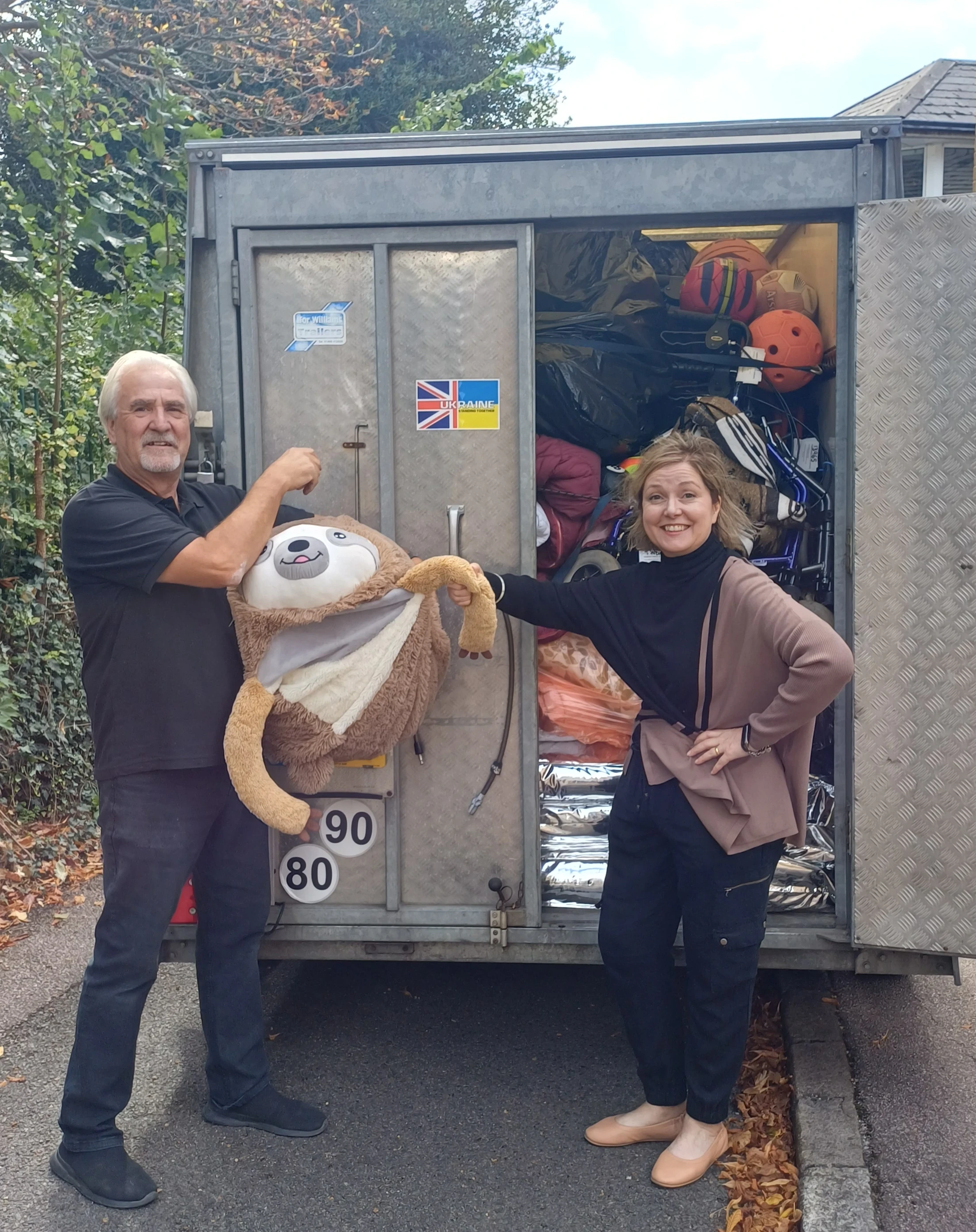 Volunteers loading the transport van with team mascot
